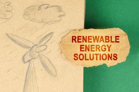 On a green surface there is a drawing with a wind generator and a cardboard.. Fotos Stock