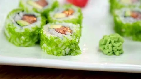Green sushi rolls served with wasabi and ginger pieces Stock Footage 333875673