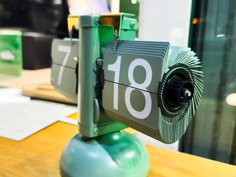 Green table clock with mechanical time change, hour and minute indication, Stock Photos