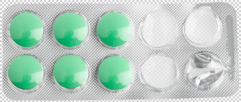 Green tablets in a blister pack. Opened packaging. Stock Photos