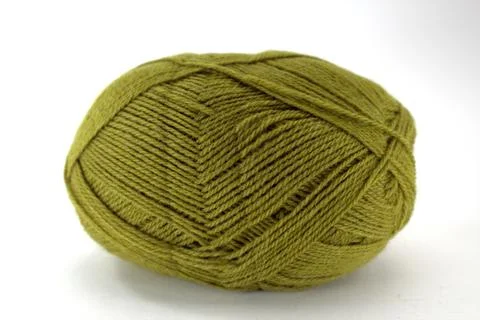 Green tangle of natural wool for needlework on white background Foto stock