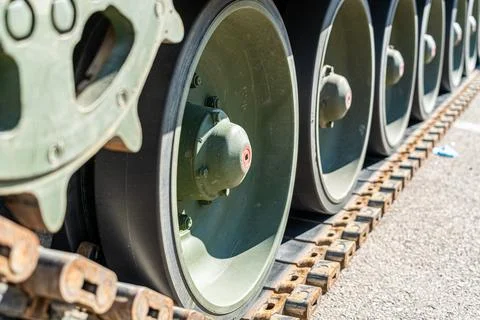 Green tank track close-up view on the asphalt during day Stock Photos