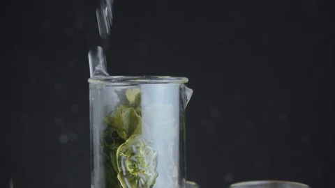 Green tea is brewed in a tea flask. Pour hot water into the tea. There is steam Video stock 89099515