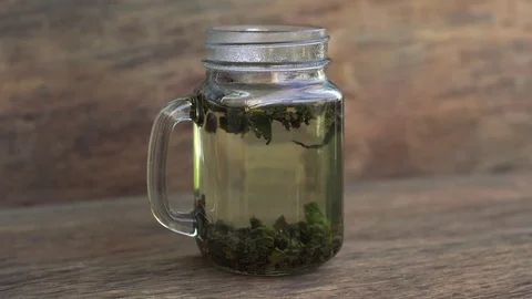 Green tea brewing process on a wooden background Stock Footage 71825181
