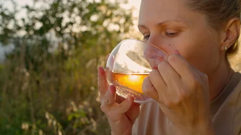 Green tea. A cup of tea in the hands of a woman. Stock Footage 278008742