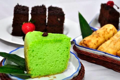 Green tea flavored sponge bread light green with raisin seeds above it Stock Photos