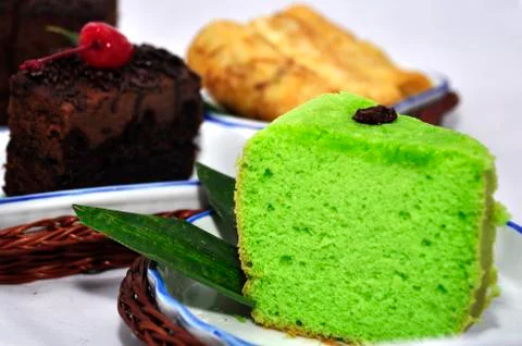 Green tea flavored sponge bread light green with raisin seeds above it Stock Photos