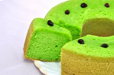 Green tea flavored sponge bread light green with raisin seeds above it Stock Photos