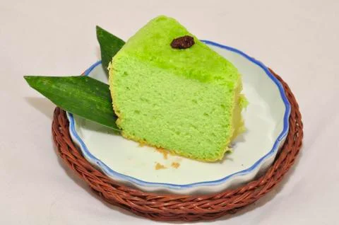 Green tea flavored sponge bread light green with raisin seeds above it Stock Photos
