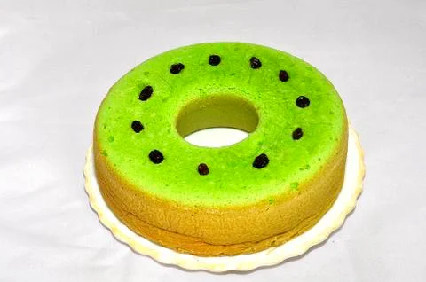 Green tea flavored sponge bread light green with raisin seeds above it Stock Photos
