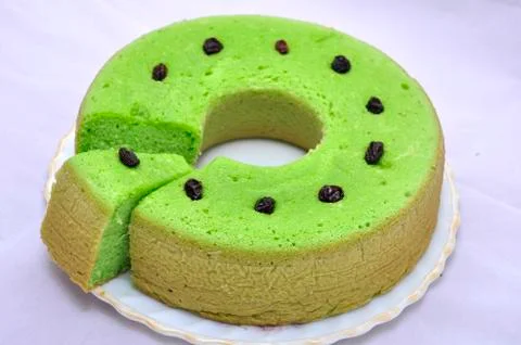 Green tea flavored sponge bread light green with raisin seeds above it Stock Photos