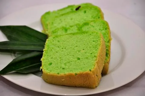 Green tea flavored sponge bread light green with raisin seeds above it Stock Photos