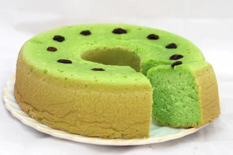 Green tea flavored sponge bread light green with raisin seeds above it Stock Photos