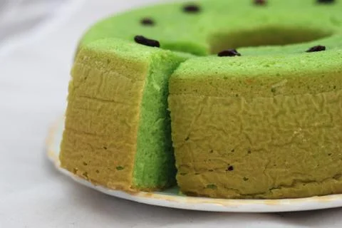 Green tea flavored sponge bread light green with raisin seeds above it Stock Photos