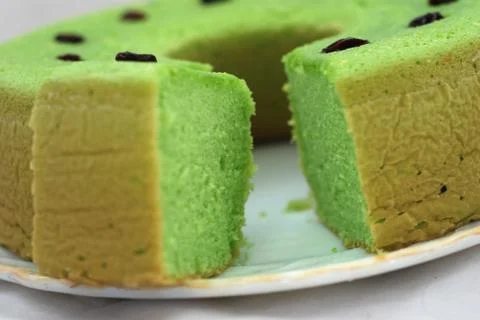Green tea flavored sponge bread light green with raisin seeds above it Stock Photos