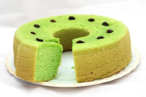 Green tea flavored sponge bread light green with raisin seeds above it Stock Photos