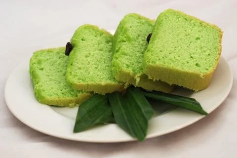 Green tea flavored sponge bread light green with raisin seeds above it Stock Photos