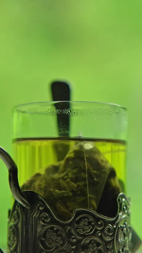 Green tea in a glass on a table in a moving train Stock Footage 335280100
