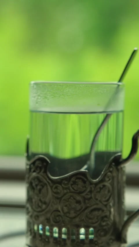 Green tea in a glass on a table in a moving train Stock Footage 335280645