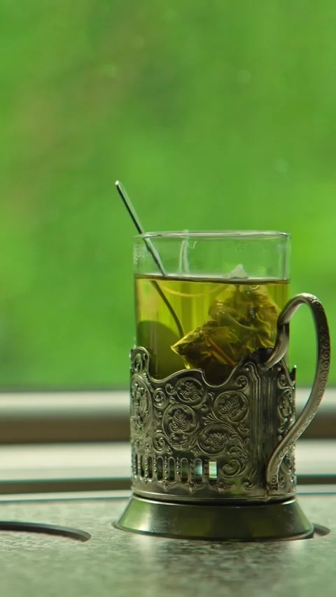 Green tea in a glass on a table in a moving train Stock Footage 335281011