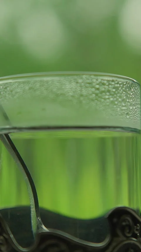 Green tea in a glass on a table in a moving train Stock Footage 335281066