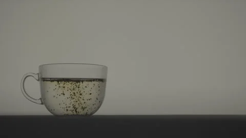 Green Tea Infusing in Water With Medium Diffusion and Color Change Stock Footage 346364212