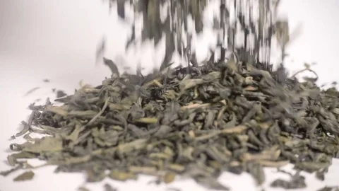 Green Tea leaves falling in slow motion Stock Footage 77392568