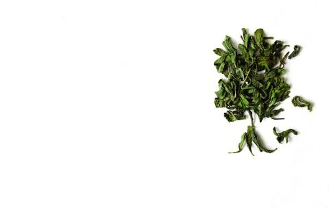 Green tea leaves in tree shape on white isolated background.Green dry tea leaves Stock Photos