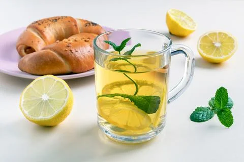 Green tea with lemon and mint in a glass cup. Stock Photos