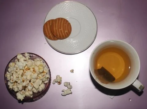 Green tea lemon flavor and teabag with biscuit and popcorn Stock Photos