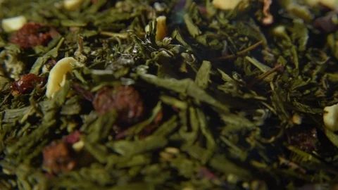 Green tea in loose form with pieces of dried fruit Stock Footage 74450705