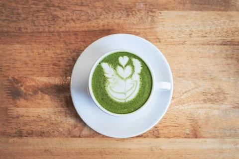 Green tea matcha latte in a cup on wooden background Stock Photos