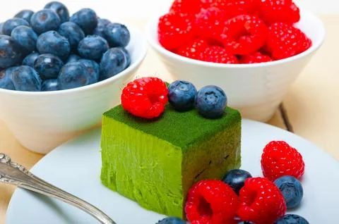 Green tea matcha mousse cake with berries Stock Photos