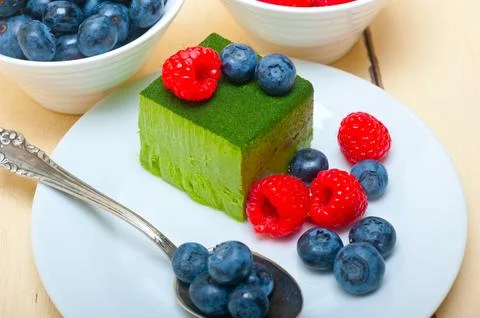 Green tea matcha mousse cake with berries Stock Photos