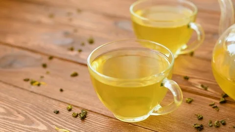 Green tea with mint, rose, goji berries and pineapple in teapot Stock Footage 73601552