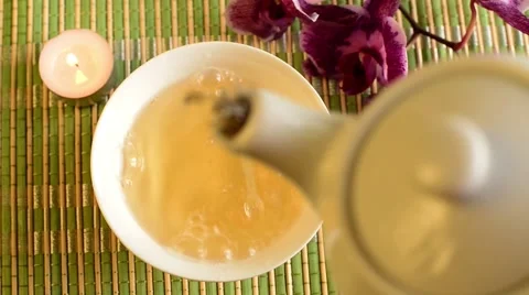Green tea is poured from a teapot Video stock 64273134
