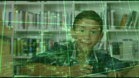 Green technical grid fading in over library table assisting school boy writing Video stock 320068839