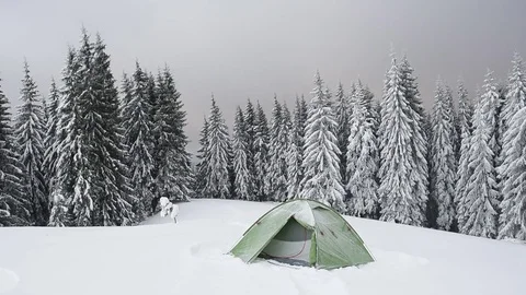 Green tent in winter mountains Stock-Footage 83359793