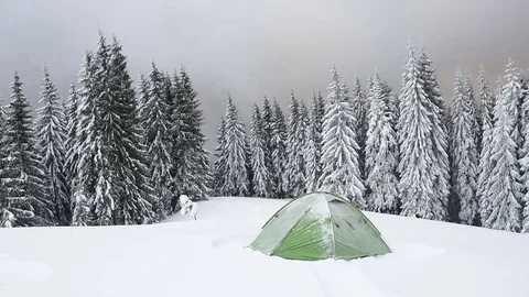Green tent in winter mountains Video stock 83359974