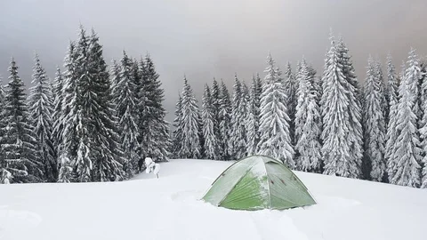 Green tent in winter mountains Stock Footage 83360374