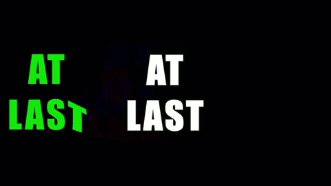 Green text AT LAST animating against dark background with subtle glitch effec Stock Footage 344283301