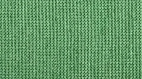 Green textile background with dense structure Stock Photos