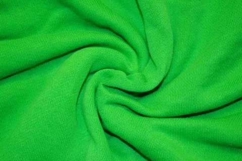Green textile pattern as a background. Green material texture on fabric Stock Photos