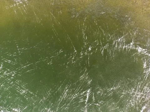 Green texture with white stripes. The texture of the ice lake. Stock Photos