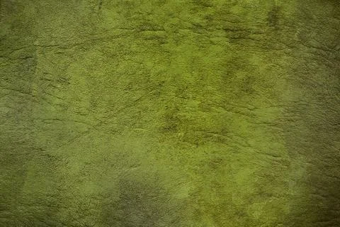 Green textured background creating rough uneven surface with light and shadow Stock Photos