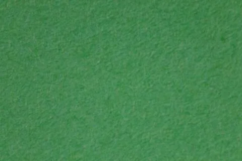 A green textured background. Stock Photos