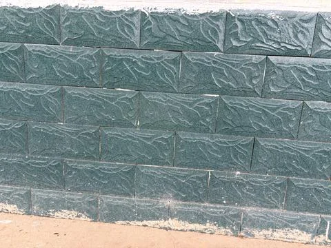 Green Textured Brick Wall with Leaf Pattern Fotos de archivo