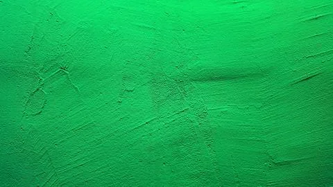 Green textured plaster wall background with subtle rough surface and light gr Stock Photos