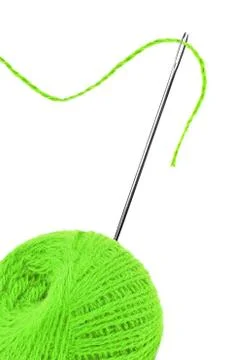 Green thread ball and needle with pink thread isolated on white Stock Photos