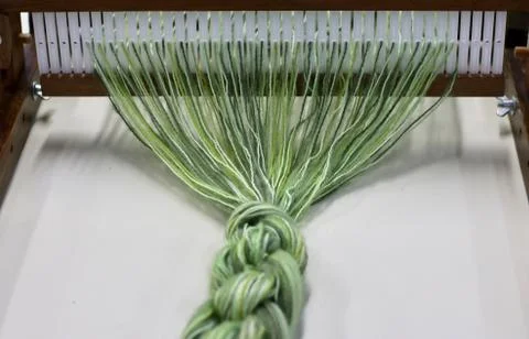 Green thread in the manual weaving machine Stock Photos